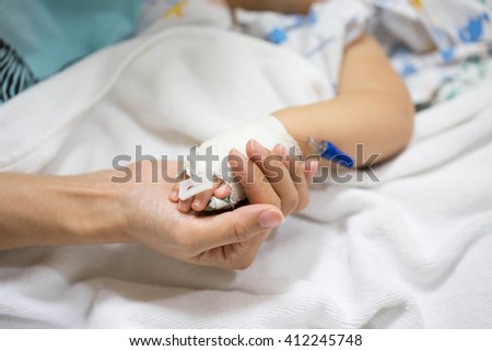 Mother holding a baby hand in hospital. Royalty-Free Stock Photo #412245748