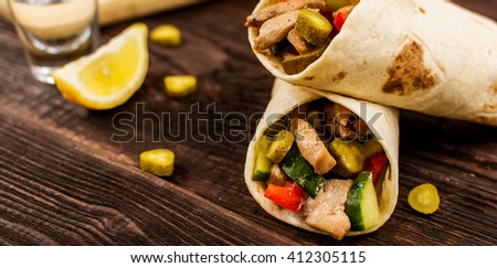 Traditional mexican tortilla wrap with meat and vegetables