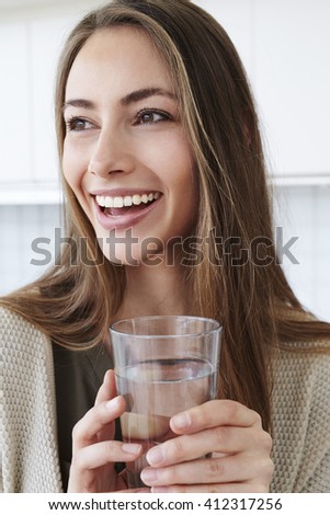Beautiful brunette woman with glass of water