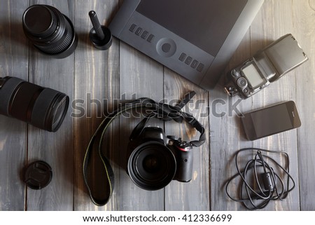 Creative concept of a designer's work office desk with tablet and camera. Top view with copy space