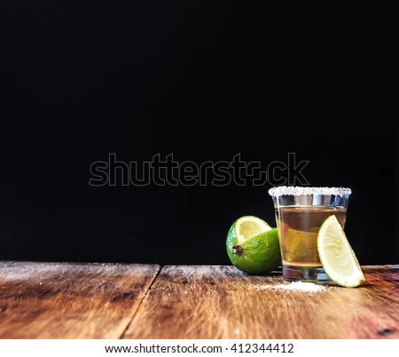Tequila shot with lime slice with free text space. Royalty-Free Stock Photo #412344412