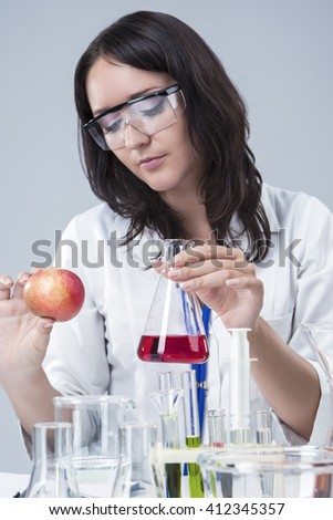 Medicine and Science Concepts and Ideas. Caucasian Female Researcher Investigating Organic Fruits in laboratory.