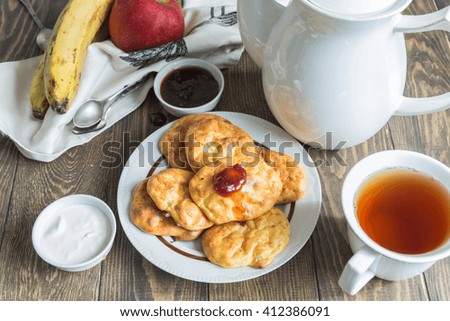 Banana cheese scones for Breakfast with jam,sour cream.Tea, fruit.