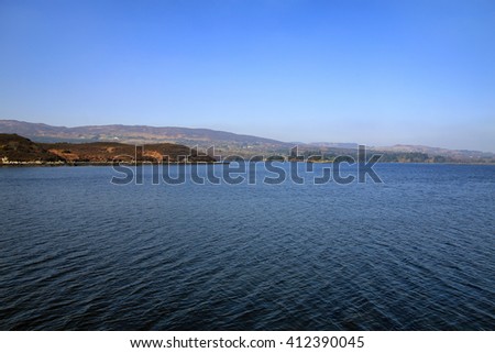 View across broadwater, mulroy bay, with blue skies and sea