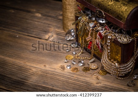 Treasure chest on wooden background, space for text