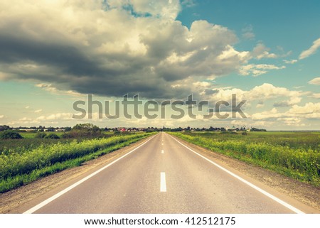 View of the new highway to the small settlement. Royalty-Free Stock Photo #412512175