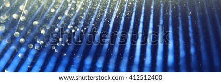 metallic glitter vintage lights website banner background. blue, silver, gold and black. defocused.
