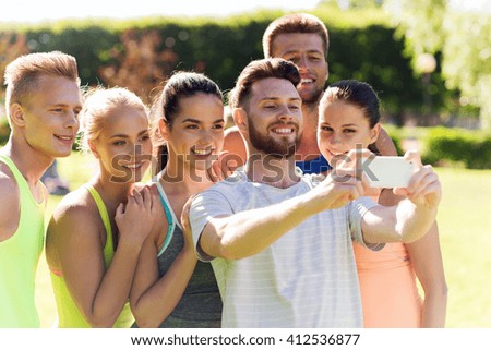 fitness, sport, friendship, technology and healthy lifestyle concept - group of happy teenage friends or sportsmen taking selfie with smartphone outdoors