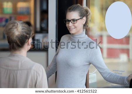 New shop, owner at the door with customer
