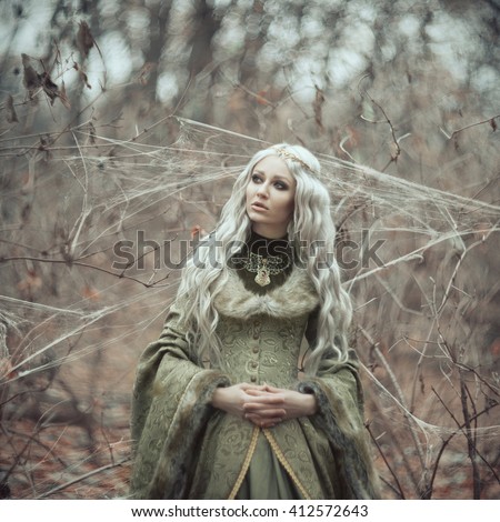 Beautiful girl with long white hair walking in the forest.