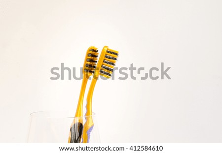 Two toothbrushes Represents lovers  in different moments .