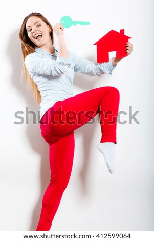 Happy young woman girl holding red paper house and key dreaming about new home house. Housing and real estate concept.