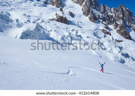 Mature female skier celebrating on Mont Blanc massif, Graian Alps, France