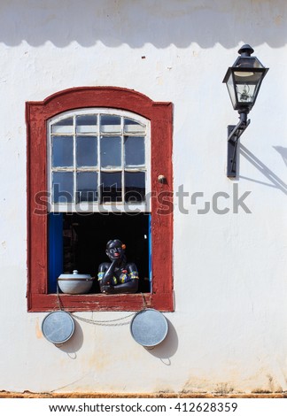 traditional brazilian souvenir girl at the country house window
