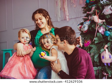 Two cute daughters together with their parents