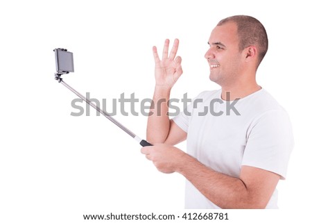 Man getting a selfie with stick isolated on white background