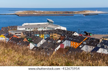Roofs of Residential area in Heligoland. Top view of traditional colorful holiday homes. Island Helgoland, Germany, in background island Dune
