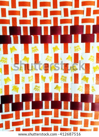 Decorative patterns woven baskets of beautiful red gold and orange plastic