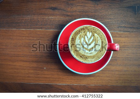 red  cup of hot coffee on wooden table in coffee shop,red cup