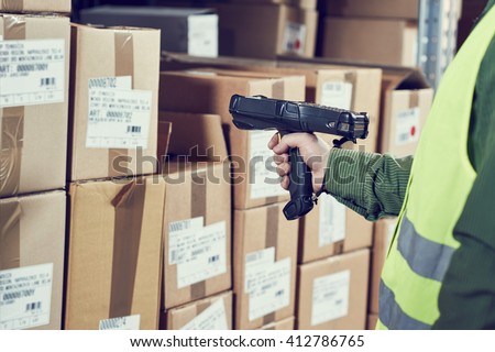 Warehouse Management System. Worker with barcode scanner Royalty-Free Stock Photo #412786765