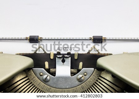 Close-up of word August on typewriter sheet