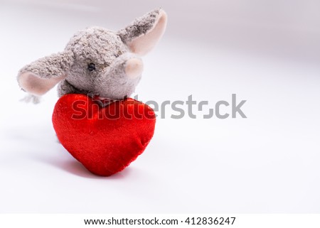 Plush Elephant with Red Heart. Soft and selective focus.