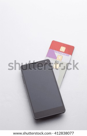 Mobile smart phone with bunch of credit card, Electronic payments concept image.