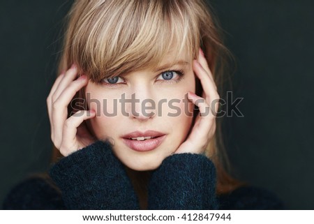 Stunning young woman with blond hair, studio Royalty-Free Stock Photo #412847944