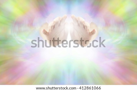 Life Force Healing Energy - female hands emerging from vibrant rainbow colored energy field with white light beneath and plenty of copy space Royalty-Free Stock Photo #412861066