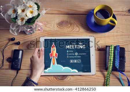 Laptop computer, tablet pc and Business meeting design concept on wooden office desk with copy space. Business meeting design concept background with rocket. 
