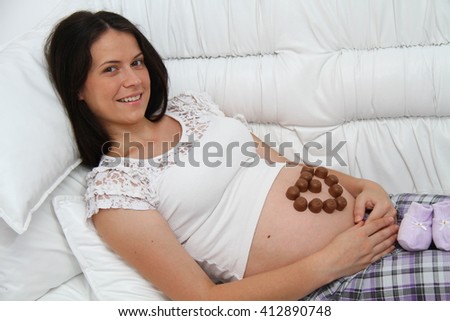 Young pregnant brunette woman relaxing