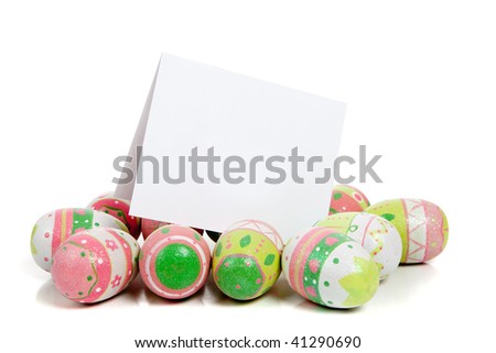 A row of decorated pastel easter eggs on a white background with a blank notecard