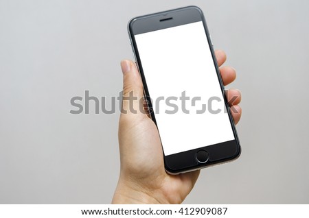 Close up hand holding black phone on white clipping path inside. Royalty-Free Stock Photo #412909087