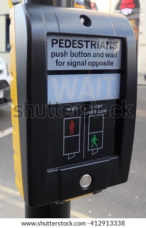 Pedestrians cross machine in London, UK