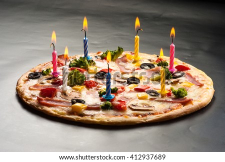 Festive candles pizza with mushrooms, cauliflower, olives, cheese and sweet pepper