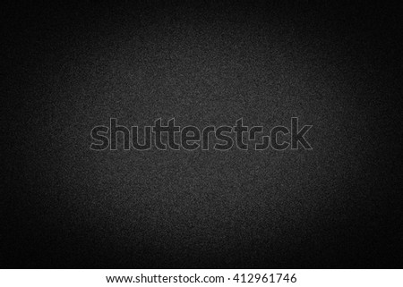 Dark black background texture with shiny speckles of random noise vignetted