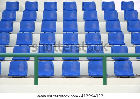 Blue stadium seats in a front view.