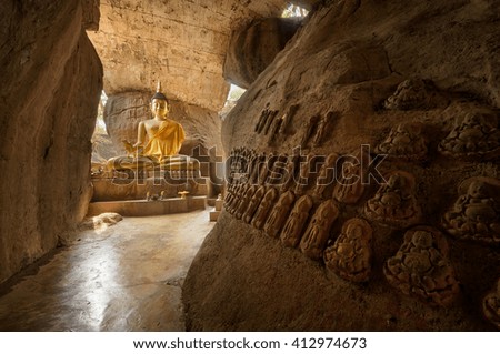 Buddha statue on the wall in cave