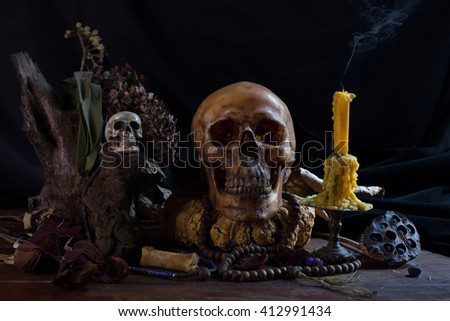 Skull and ritual on dark night with candle extinguish / Image Still life 

