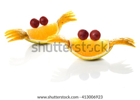 Food art creative concepts. Cute crabs made of tangerines and grapes isolated on white background