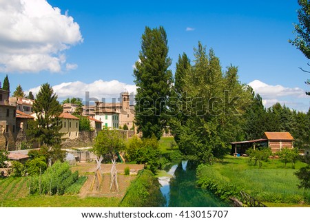 Bevagna seen from the bridge over Clitunno river; city walls and vegetable gardens