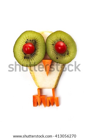 Food art creative concepts. Funny owl (bird) made of pear, kiwi, tomatoes and carrots isolated on a white background.