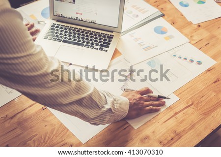 Businessman analyzing investment charts. Accounting Royalty-Free Stock Photo #413070310