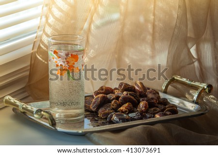 Dates and water Royalty-Free Stock Photo #413073691