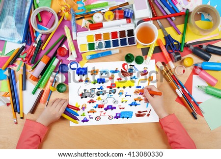 cartoon game toy and people collection child drawing , top view hands with pencil painting picture on paper, artwork workplace