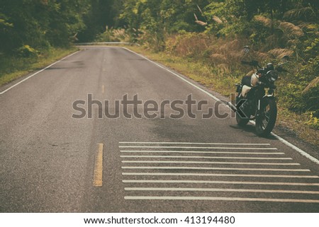 Vintage motorcycle on beautiful route in grunge style 