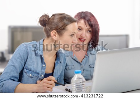 two young women college working on a laptop computer