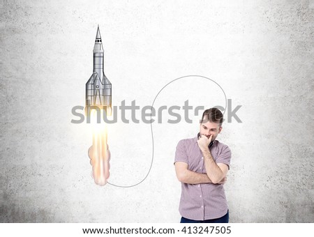 Start up concept with thinking caucasian guy standing against concrete wall with sketch Royalty-Free Stock Photo #413247505