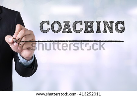 COACHING Businessman drawing Landing Page on blurred abstract background