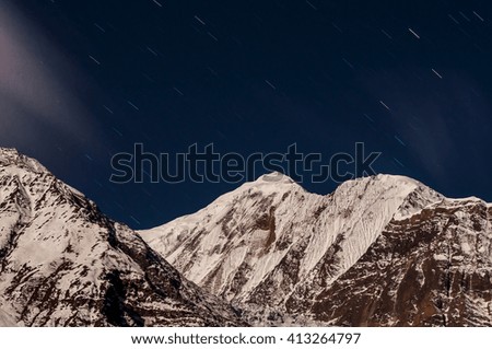 Star trails over Mt. Gangapurna, Annapurna Range, Nepal.